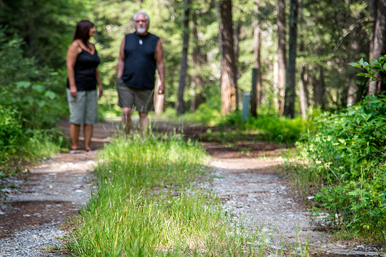 Mark and Valerie Sigler walk in the woods surrounding their home outside Bozeman, Montana. The Siglers owned and operated a number of medical marijuana dispensaries until they were shut down by federal authorities in 2011.