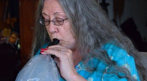 Medical marijuana patient Teri Heede takes a hit from a vaporizor in her Oahu home on June 21. Photo by Anne M. Shearer/News21